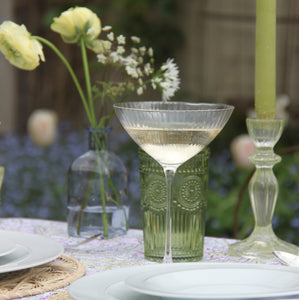 champagne coupe and green candlestick