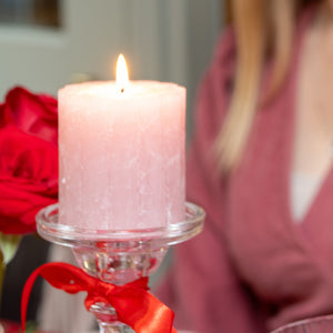 Pink pillar candle on valentines table 