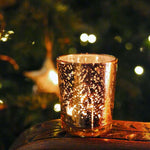 Load image into Gallery viewer, Rose-gold tealight holder votive in front of Christmas tree
