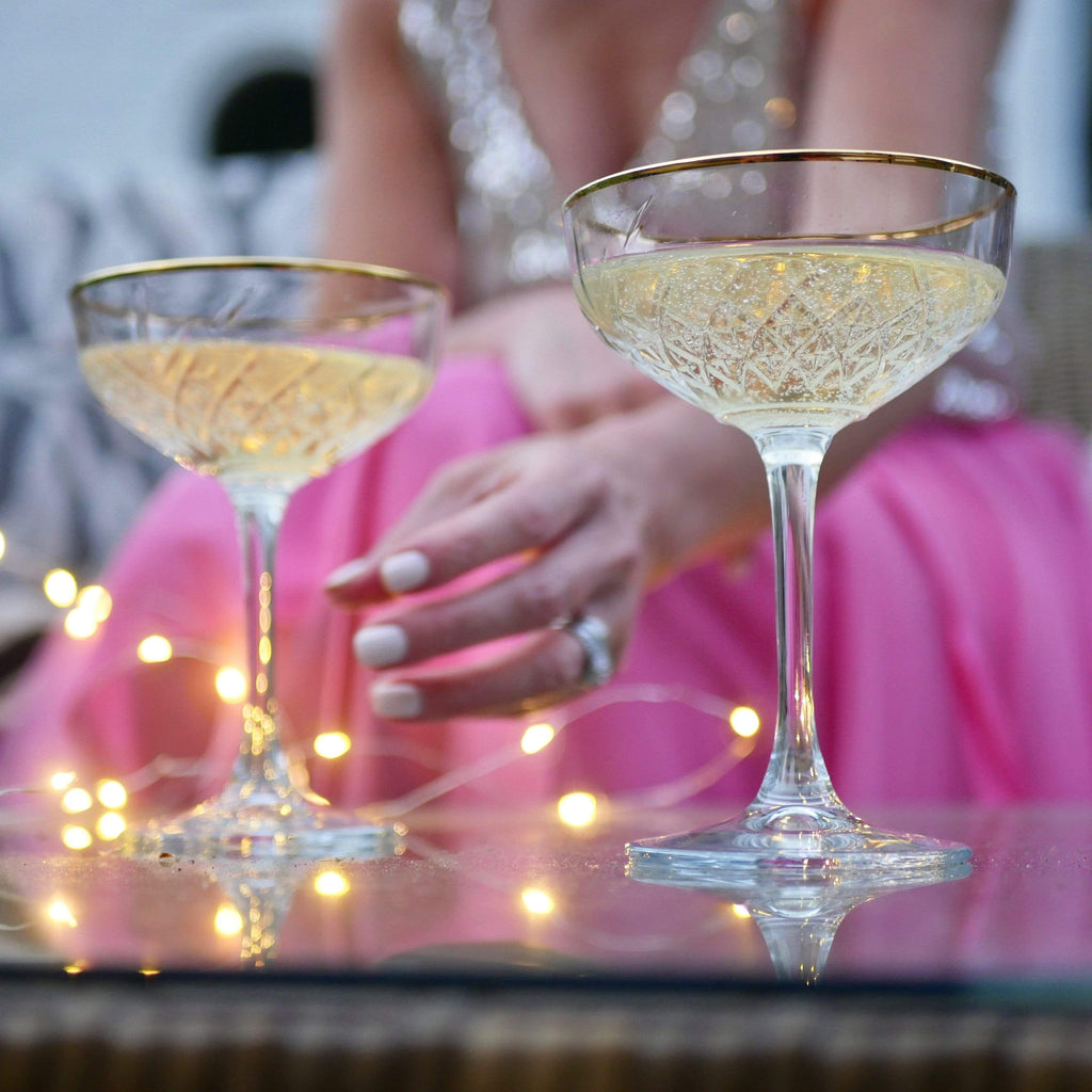 Vintage-style gold rimmed champagne saucers