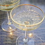 Load image into Gallery viewer, Vintage-style gold rimmed champagne saucers
